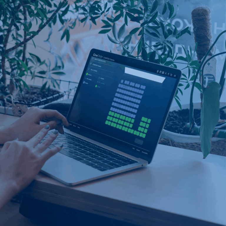Zuverlässiges Online Ticketing im COMPESO Webshop mit benutzerfreundlicher Kino-Sitzplatzwahl dank zuverlässiger Kinosoftware auf Laptop im modernen Arbeitsumfeld